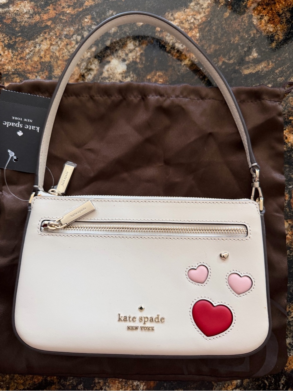 kate spade cream wristlet with pink and red heart appliqués